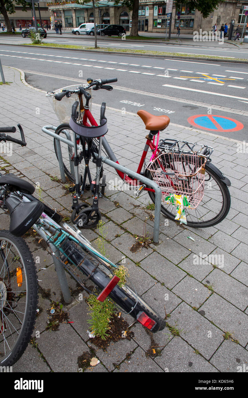Bicycle parking stands in a city, many bikes are parked here, broken