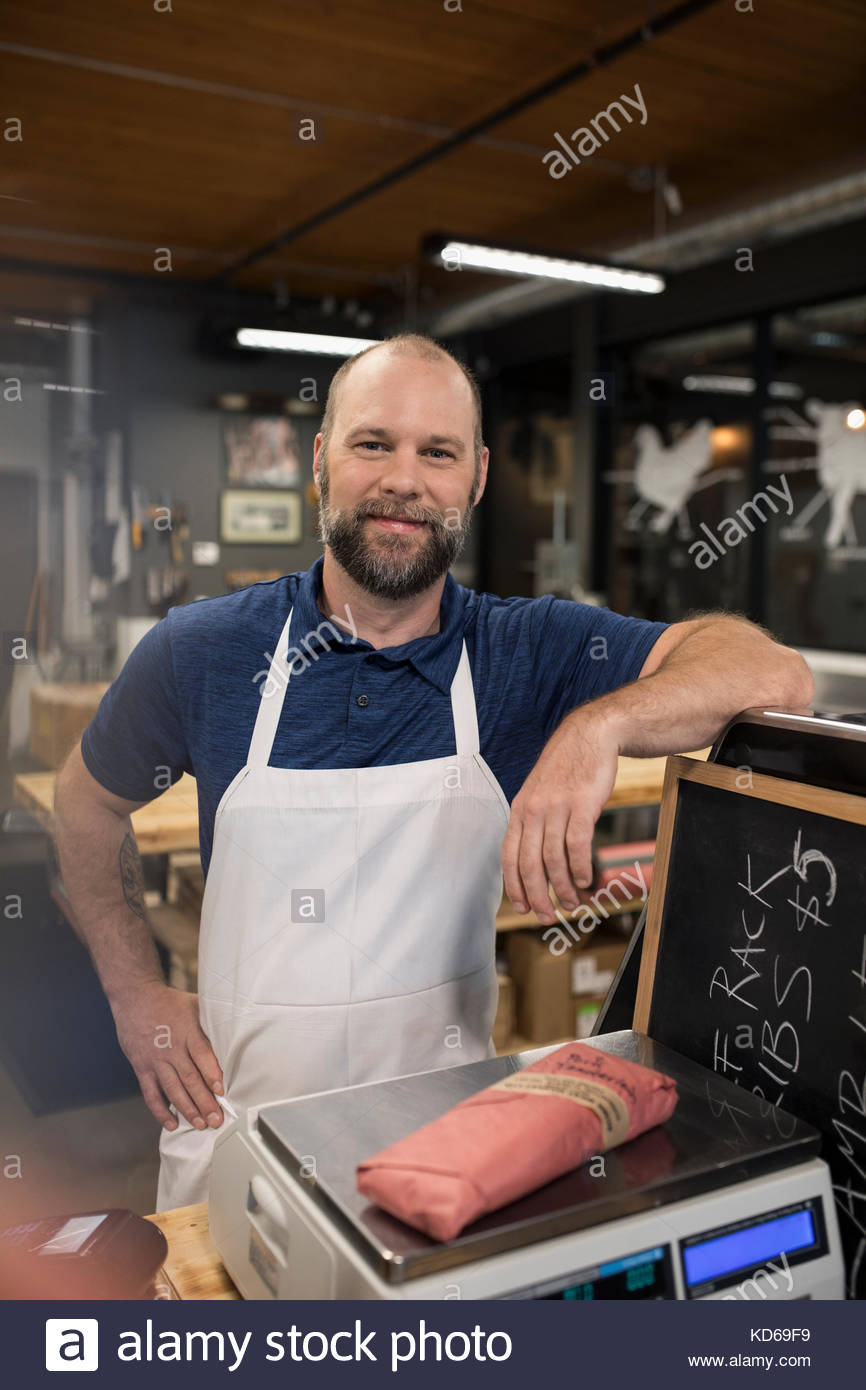 Butcher weighing meat on a scale hires stock photography and images