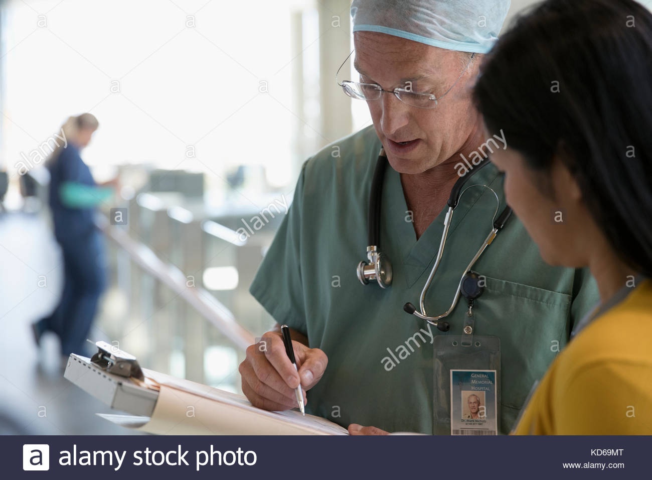 Surgeon and doctor discussing medical record in hospital Stock Photo