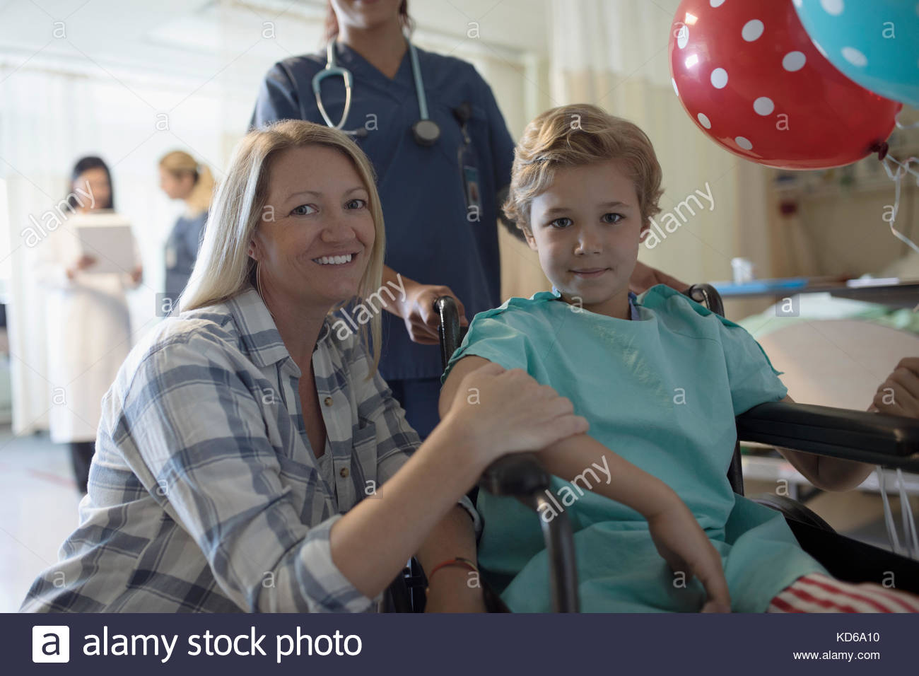 Portrait smiling mother and son boy patient in wheelchair in hospital Stock Photo