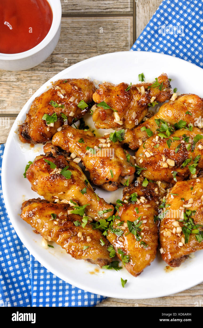 Fried chicken wings in ginger garlic marinade with herbs Stock Photo