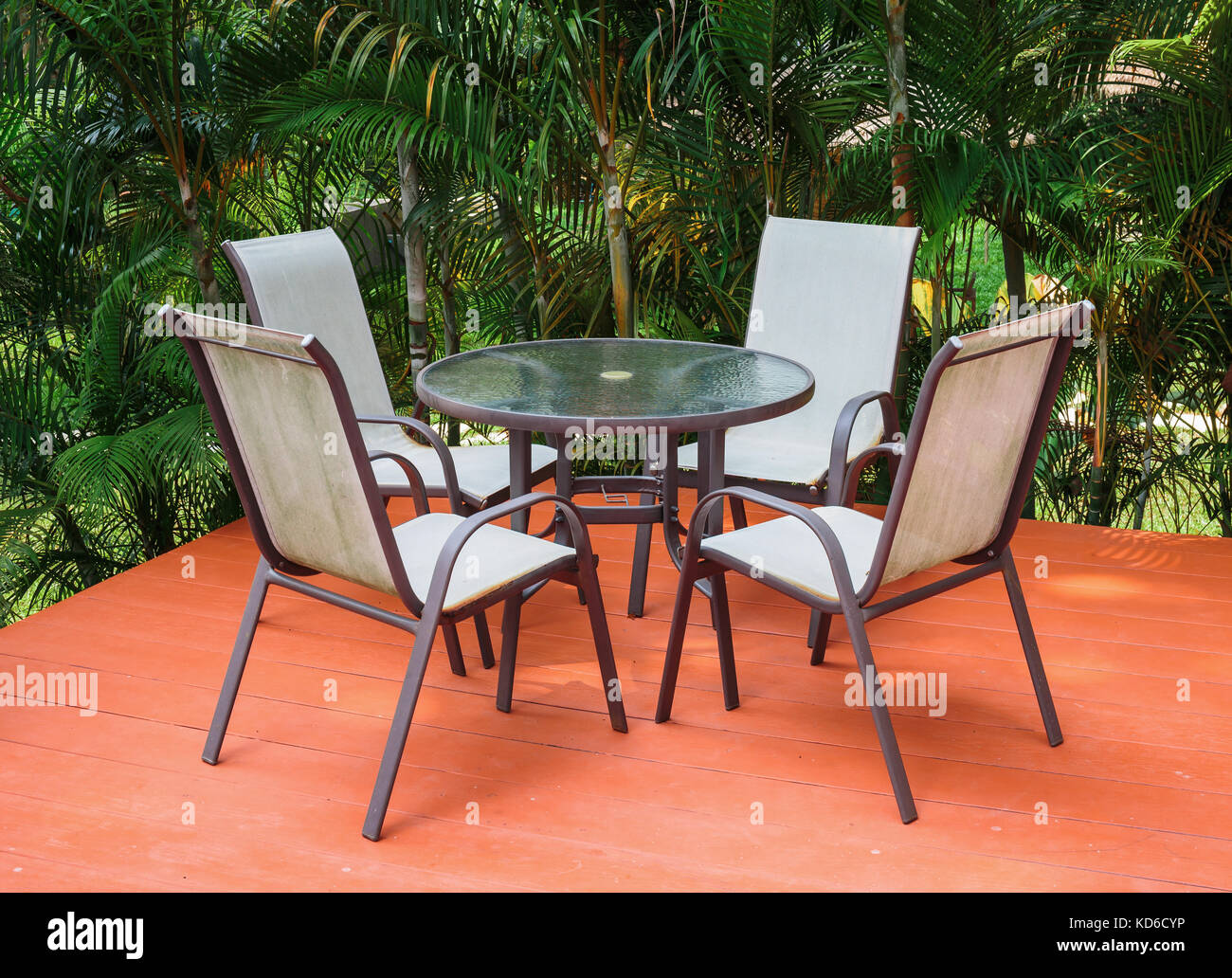 Table and chairs on the terrace in a tropical garden Stock Photo - Alamy
