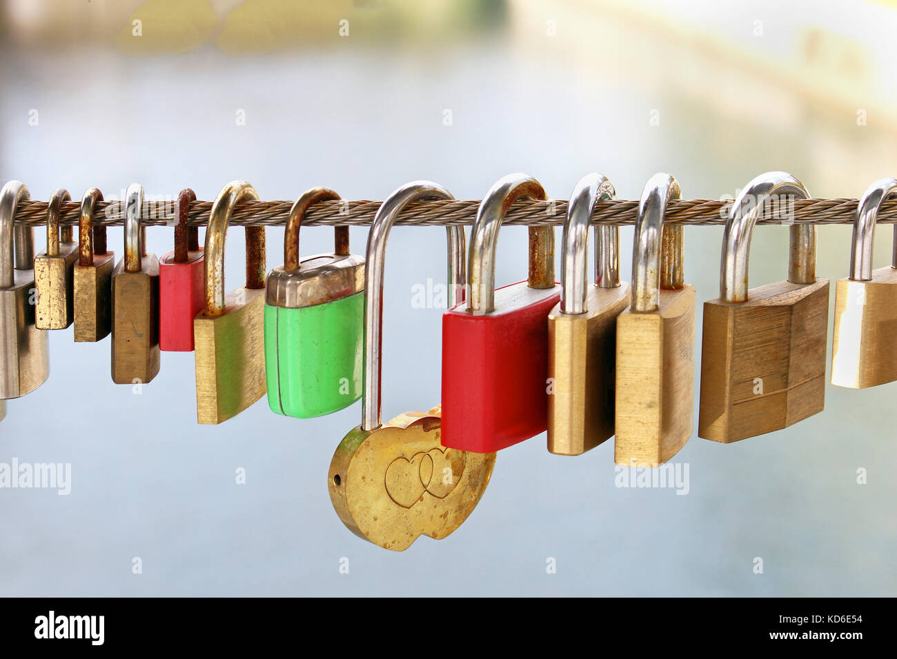 Padlocks on bridge chained to metal rope Stock Photo Alamy