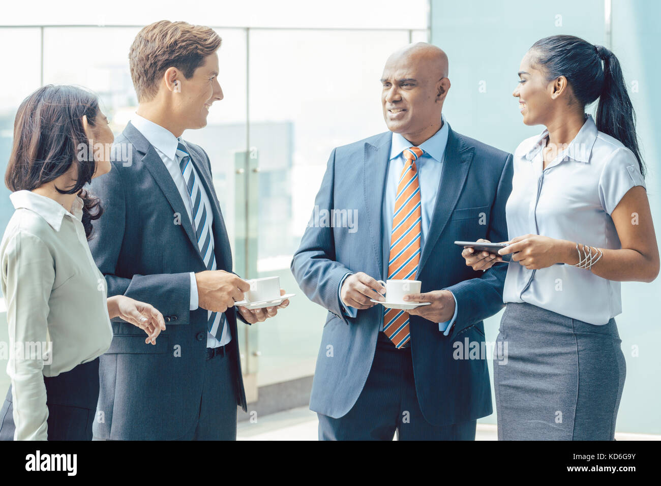 Diversity Asian business team with coffee in front of office Stock Photo