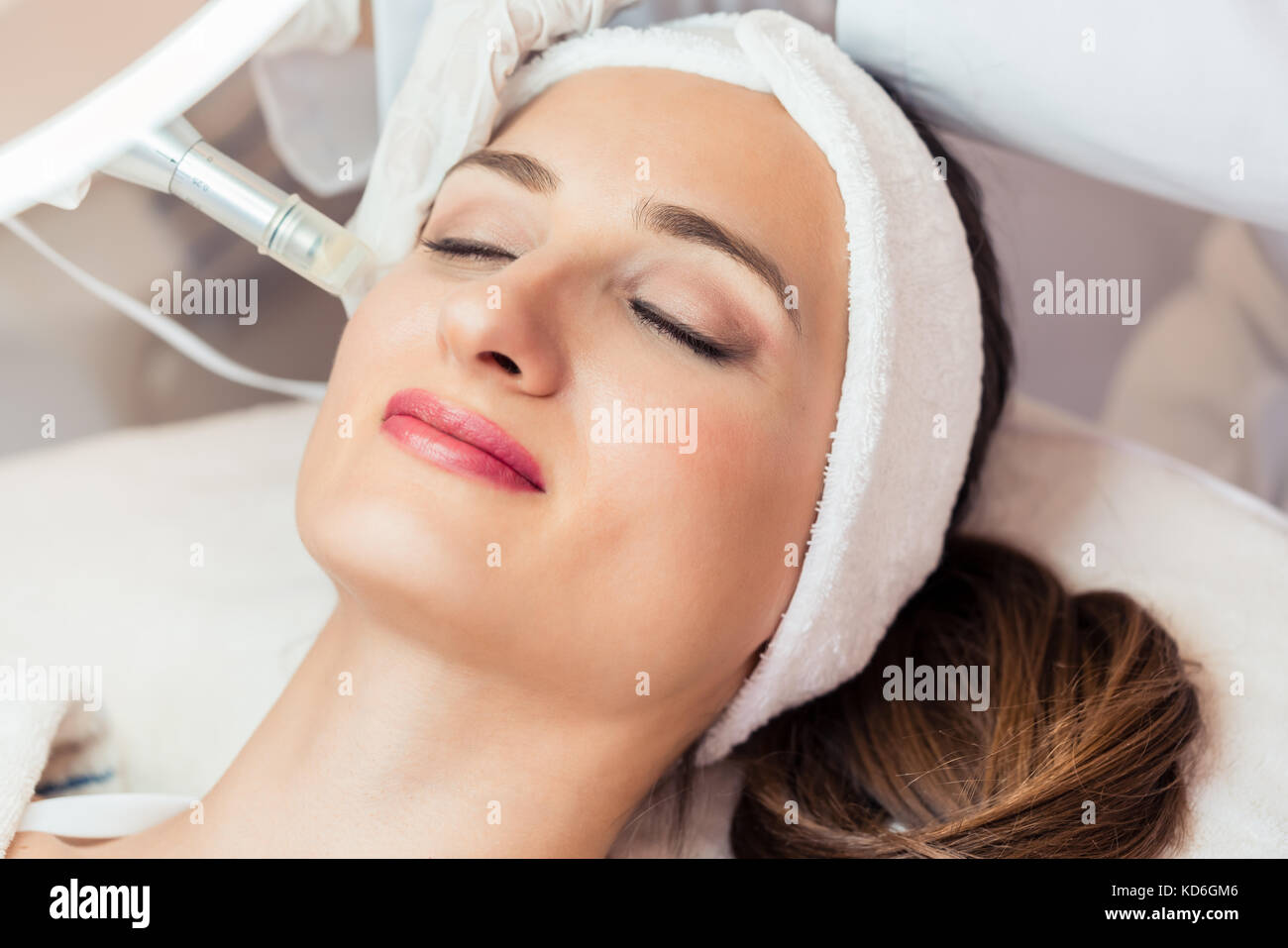 Close-up of the face of a woman relaxing during non-surgical fac Stock Photo