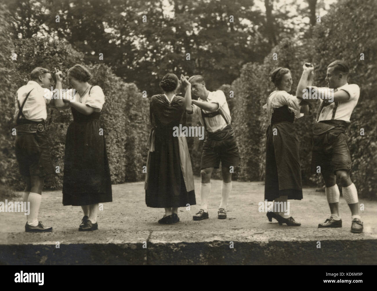 German folk dancing in the 1930s.  Part of the celebrations held in the periphery of the Salzburg Festival.  Traditional Tyrolean costume, Lederhosen. postcard Stock Photo