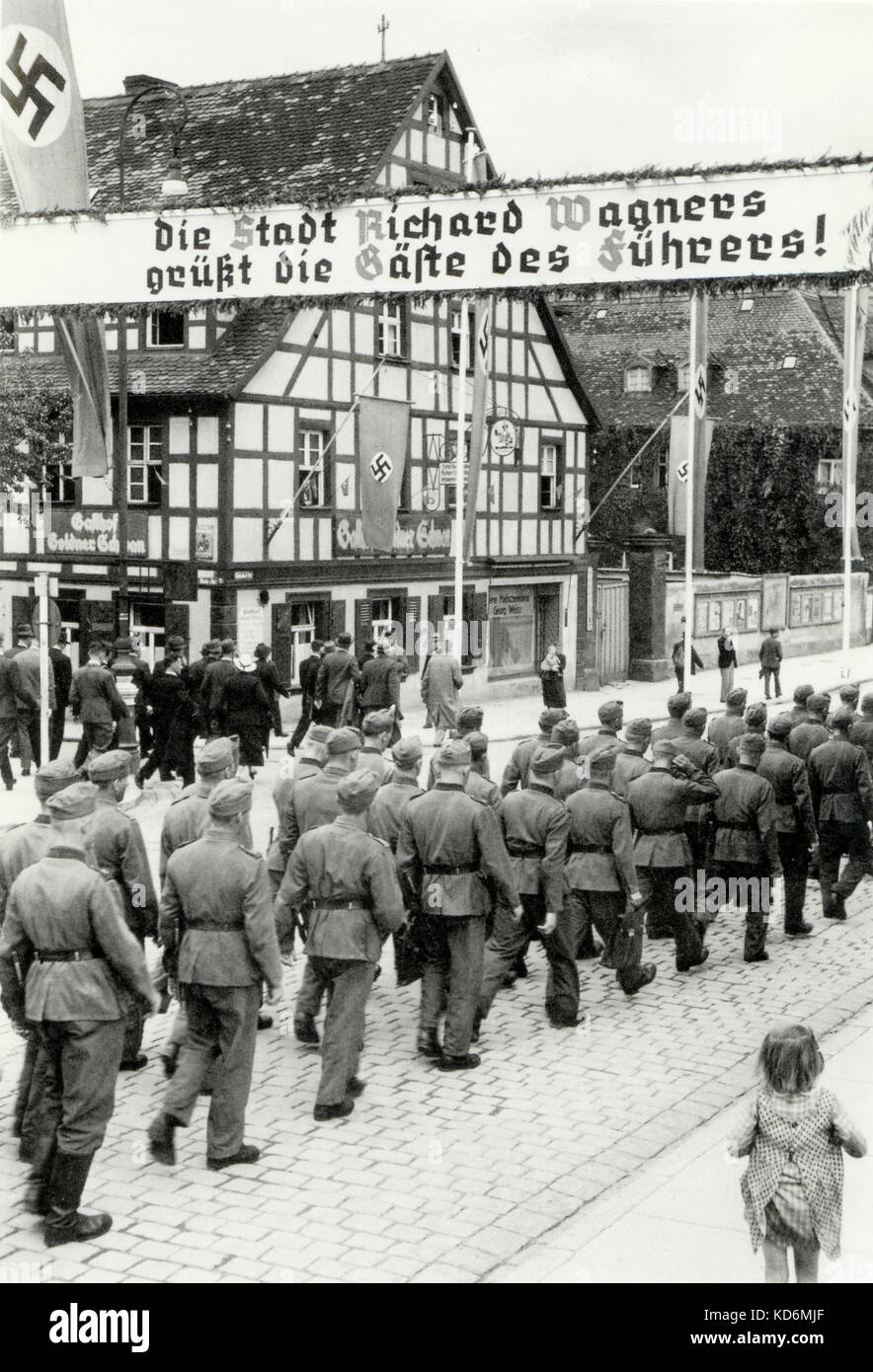 Bayreuth under Nazi rule with soldiers marching through it and swastikas on display 'Die stadt Richard Wagners geust die gafte des fuhrers', Wagner related. Stock Photo
