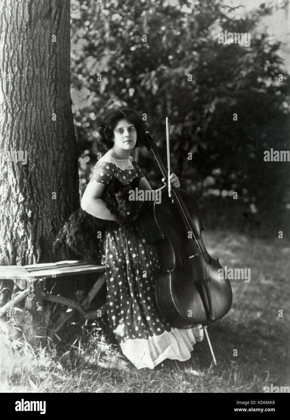 Beatrice Harrison with dog and cello at home in Surrey 1925 English cellist, 9th December 1892 - 10th March 1965 Harrison Sister's Trust Stock Photo