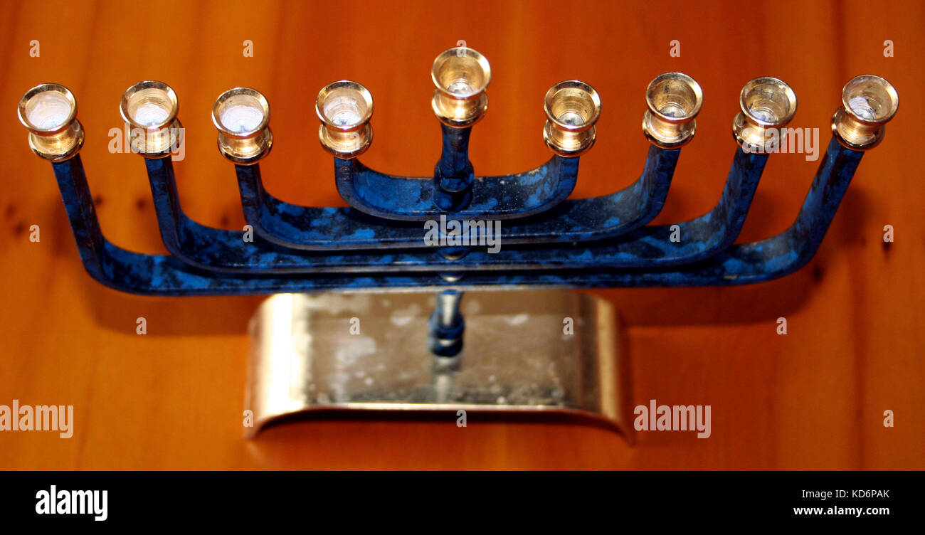 Hanukia or Menorah used to celebrate festival of Hanukah / Chanukah. 9 branched candlestick, 8 of the branches signifying the 8 days that the Eternal Light in the synagogue  grew ever brighter despite the lack of oil - regarded as the miracle of Hanukah. Hanukiah Stock Photo