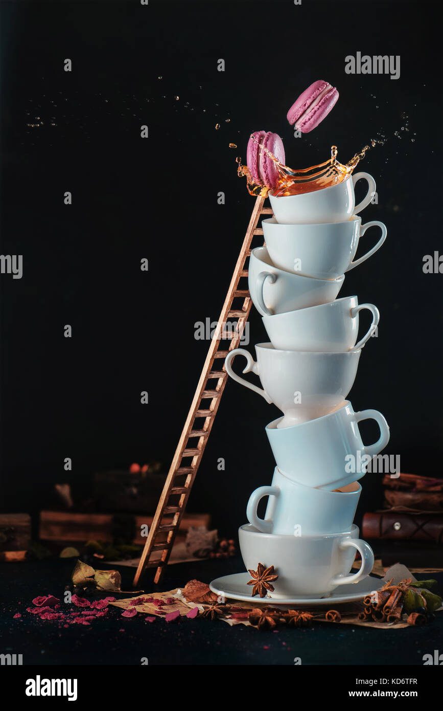 Tower Of White Coffee Cups With A Ladder Macaroons Splash And