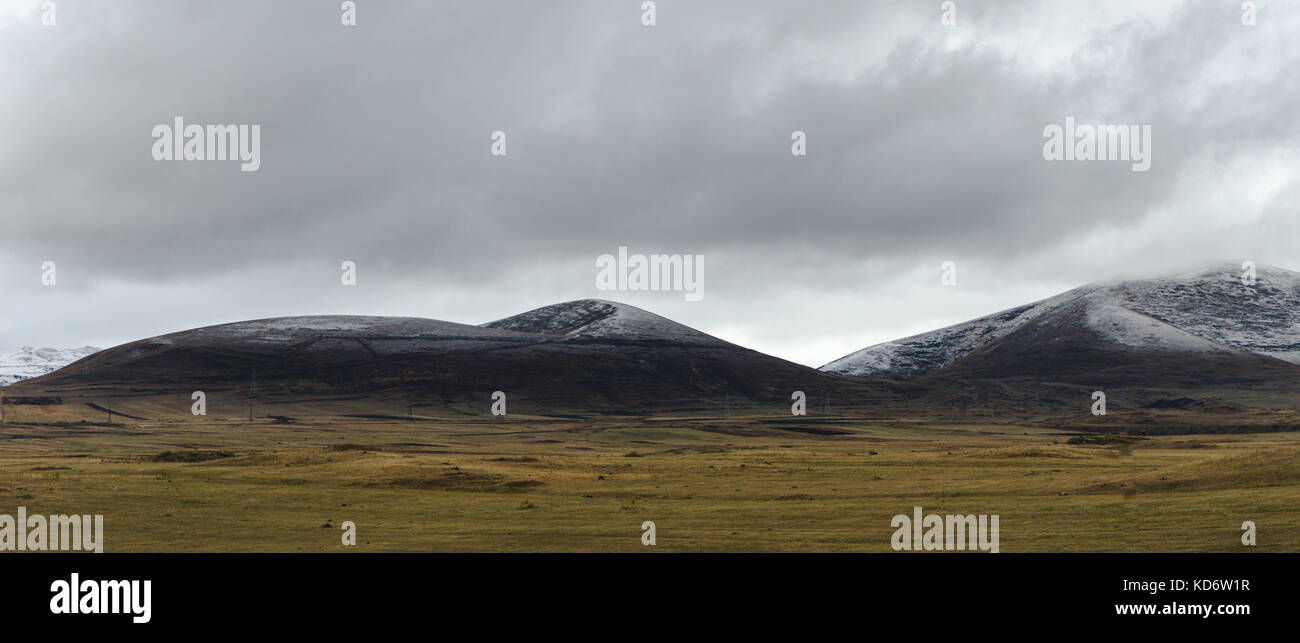 Valley, clouds and sky above the mountains in Armenia wide screen horizontal Stock Photo