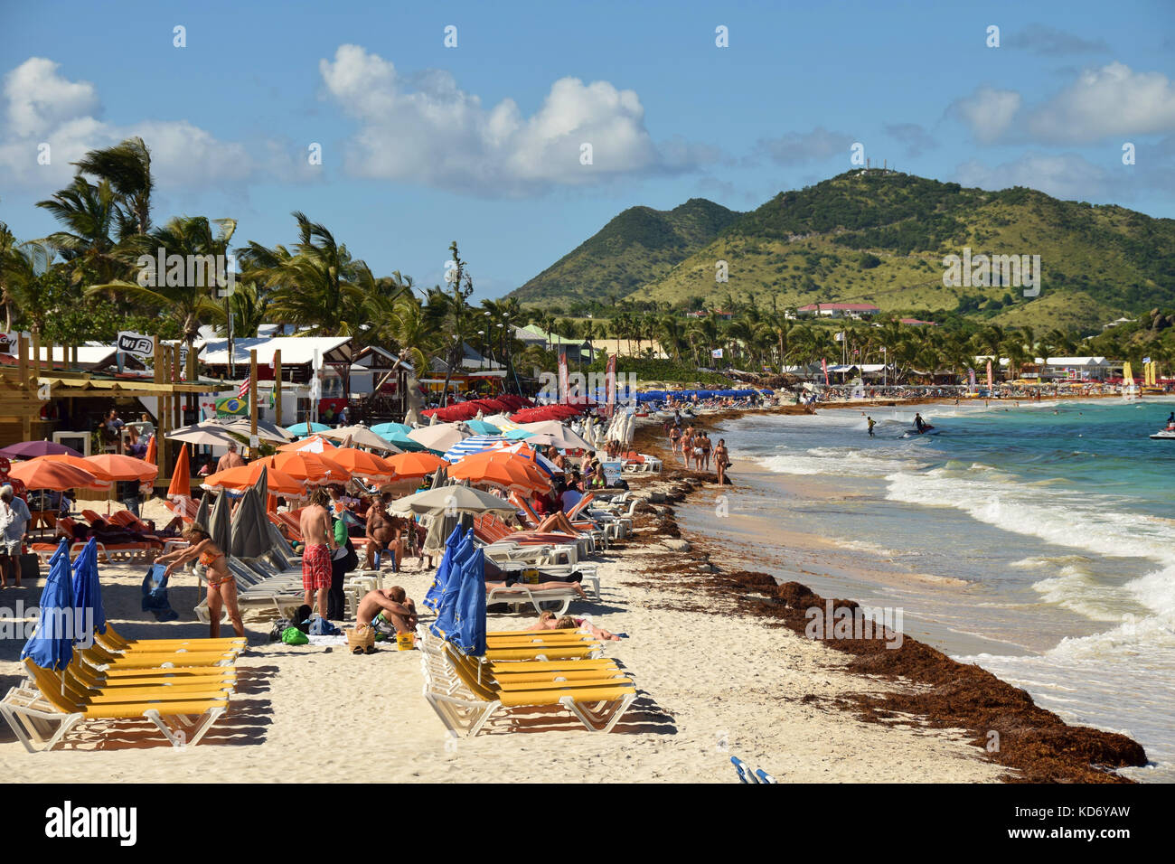 ORIENT BEACH - DECEMBER 24: Tourists enjoy a sunny day on world famous Orient Beach, Saint Maarten on December 24, 2014 Stock Photo