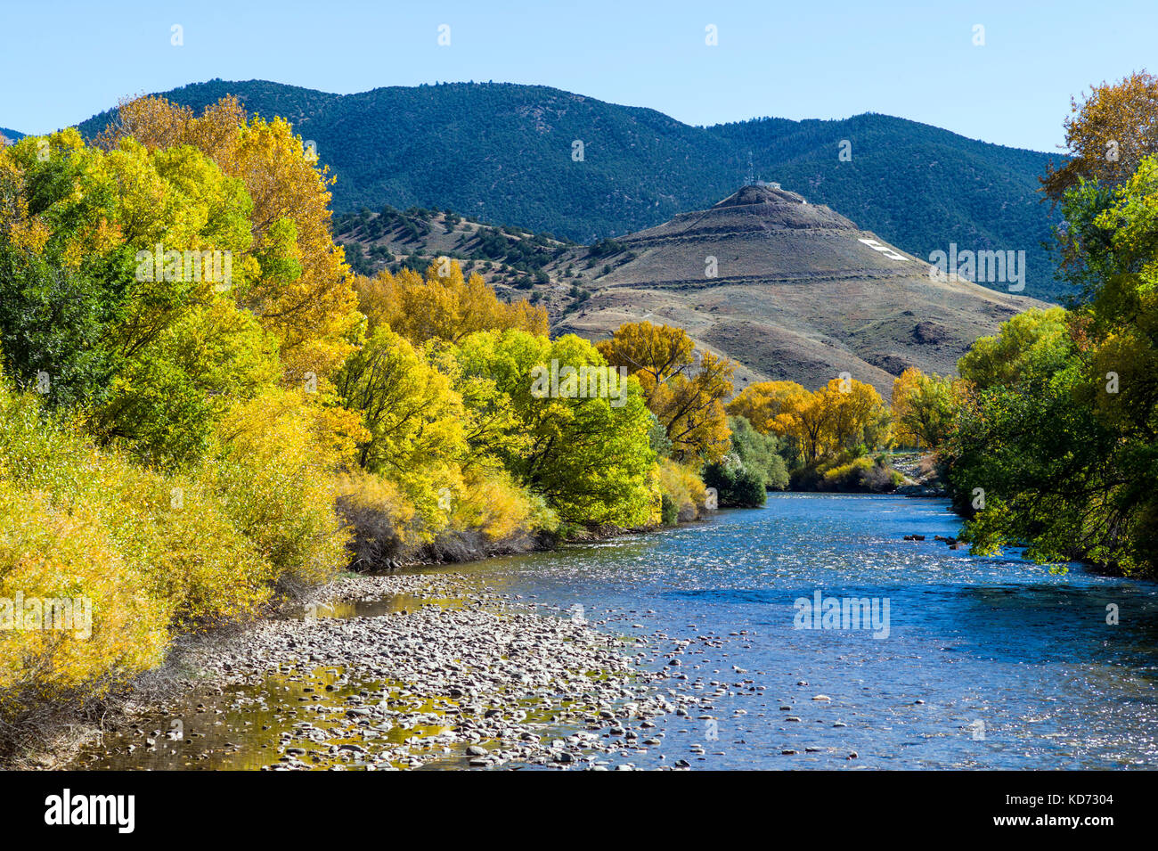 Fall foliage colors along the Arkansas RIver which runs through the downtown historic district of the small mountain town of Salida, Colorado, USA Stock Photo