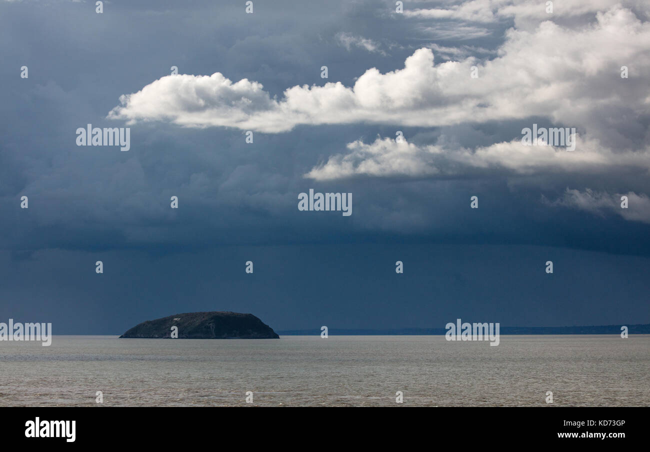 Storm clouds over the island of Steep Holm in  the Bristol Channel viewed from Brean Down in Somerset UK Stock Photo