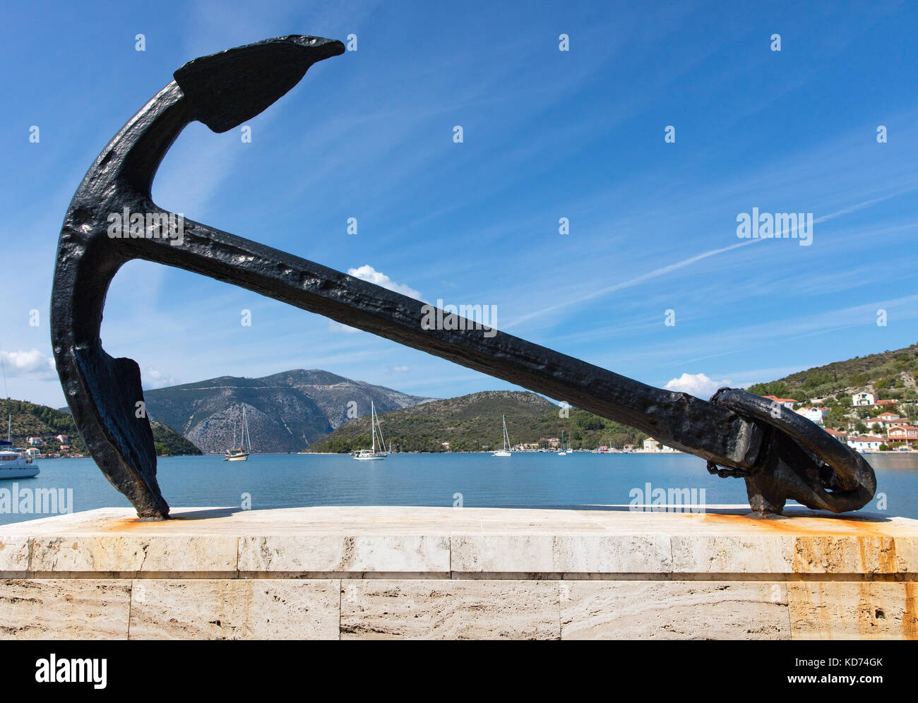 Large iron anchor set at the head of the inlet and harbour at Vathy the capital town of Ithaka in the  Ionian Islands of Greece Stock Photo