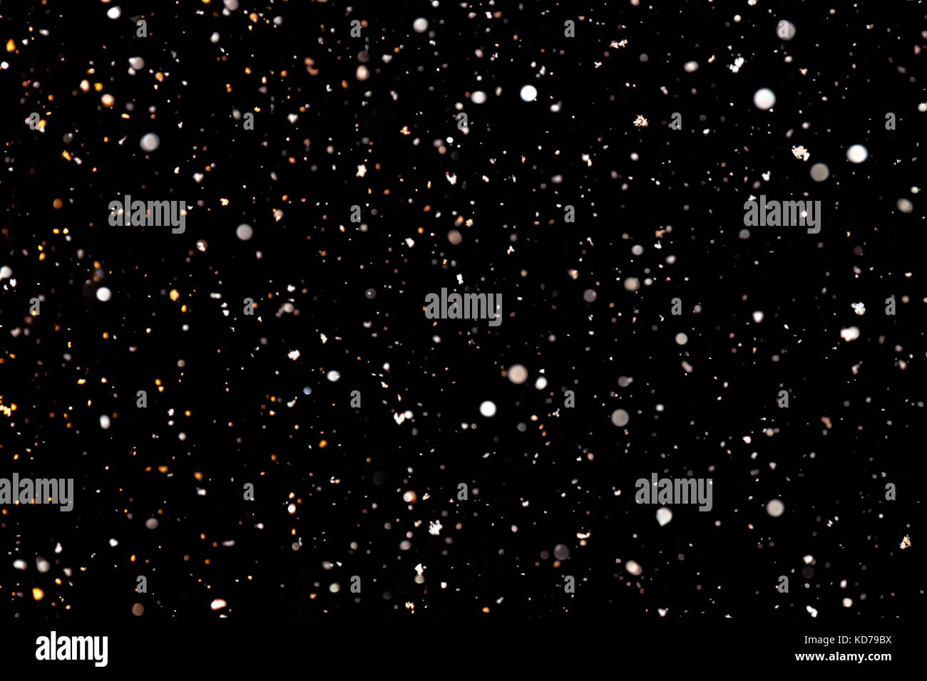 abstract background of falling snow. white snowflakes on a black ...