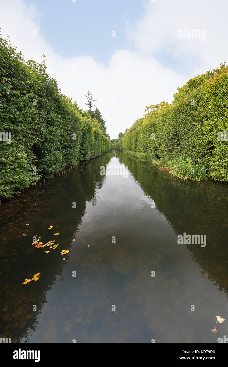 View of a water canal and lush hedge at the Oliwa Park (Park Oliwski). It's a public park in Gdansk, Poland. Stock Photo