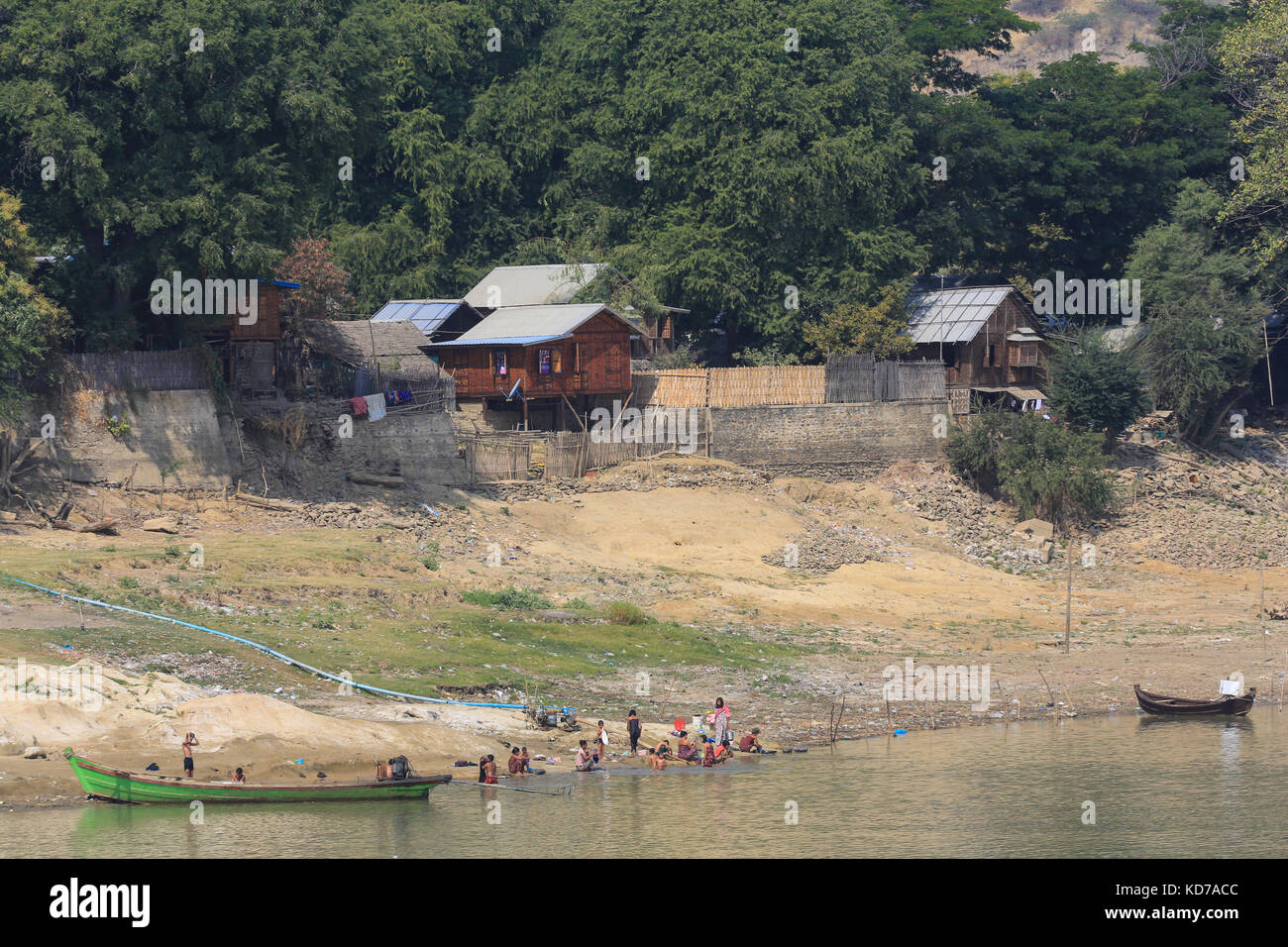 Villagers washing laundry and themselves in the Irrawaddy River, Myanmar (Burma). Stock Photo
