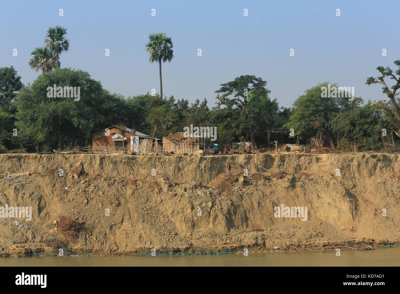 Houses adjacent to the eroding banks of the Irrawaddy River in Myanmar (Burma). Stock Photo