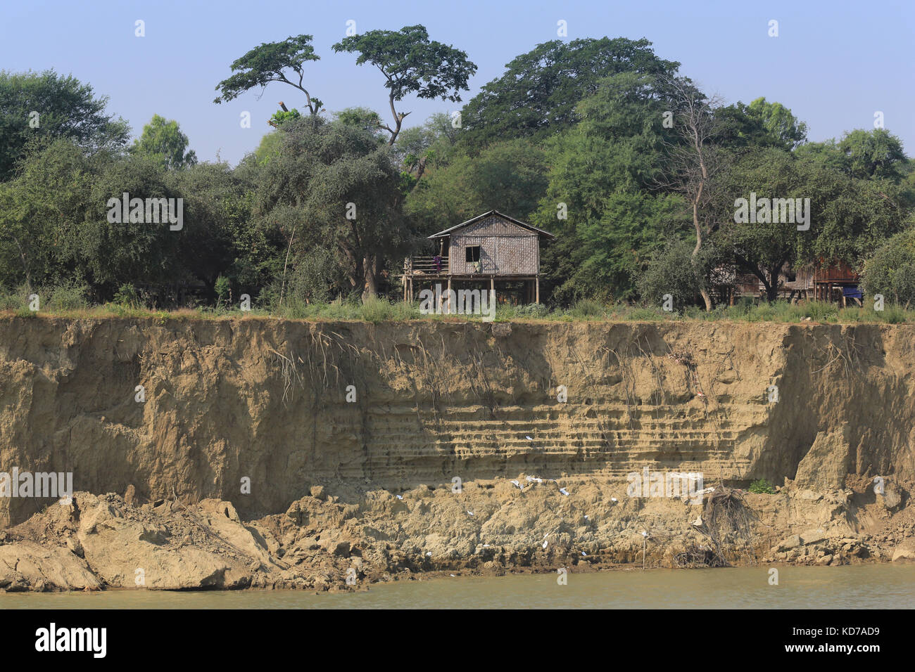 Houses in Kon Zaung Village adjacent to the eroding banks of the Irrawaddy River in Myanmar (Burma). Stock Photo