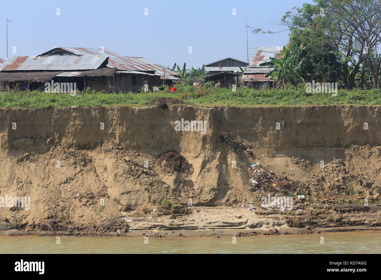 Buildings threatened by undermining along an eroding reach of the Irrawaddy River in Myanmar (Burma). Stock Photo