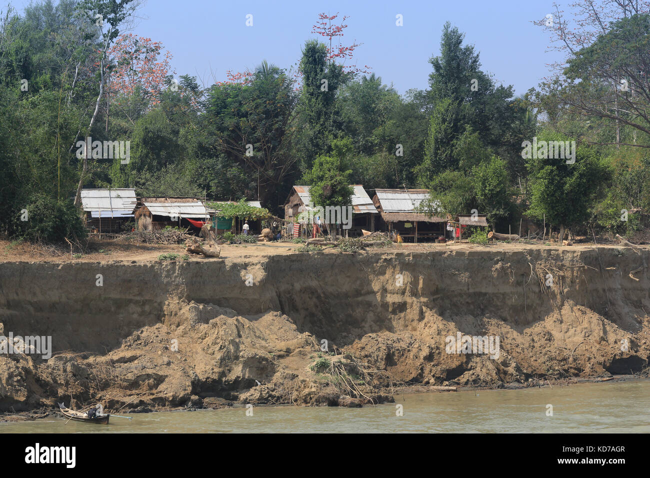 Boats are moored and beached along an eroding reach of the Irrawaddy River in Myanmar (Burma). Stock Photo