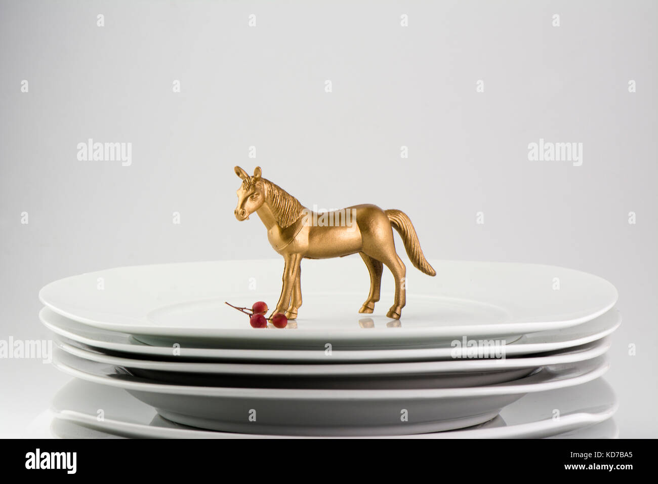 White Plates stacked dishes and clean white horse and gold tableware, conceptual food Stock Photo