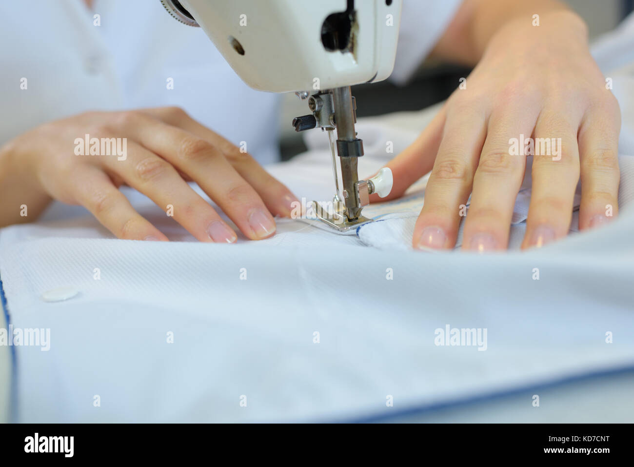 close up hands of young seamstress working on sewing machine Stock ...