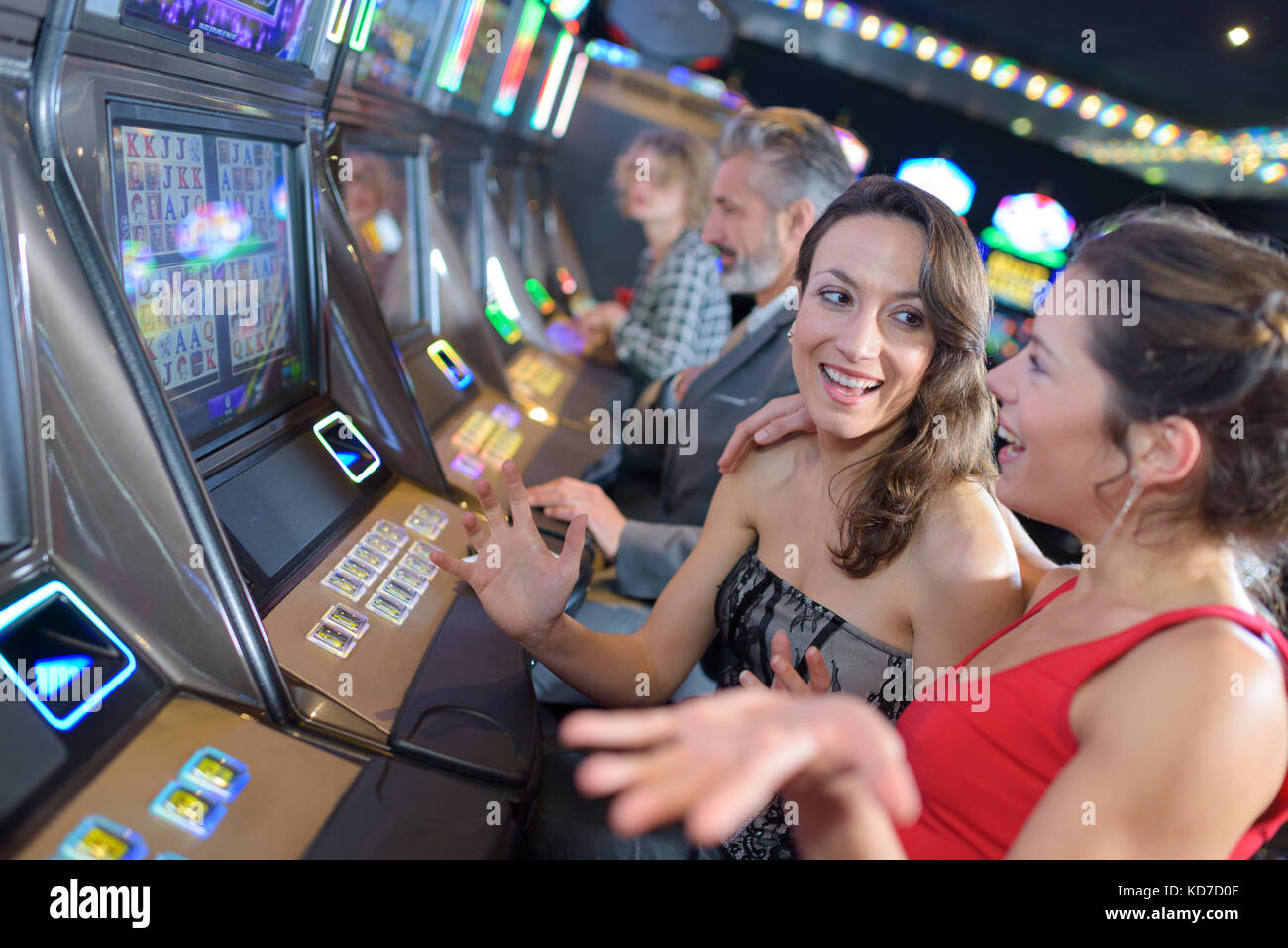 group of people playing slot and various machines Stock Photo - Alamy
