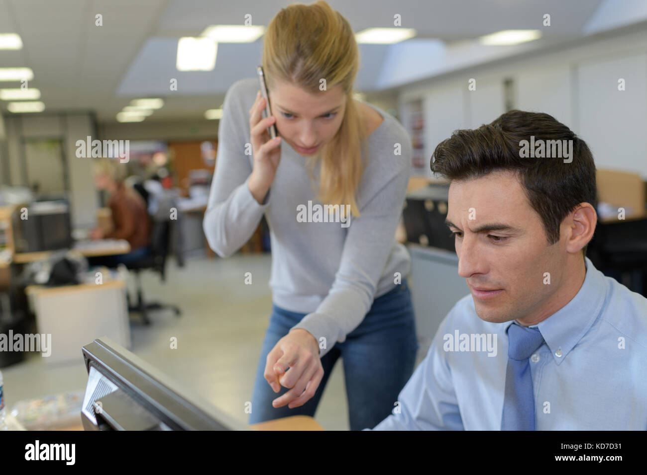 woman assisting male computer clerk Stock Photo Alamy