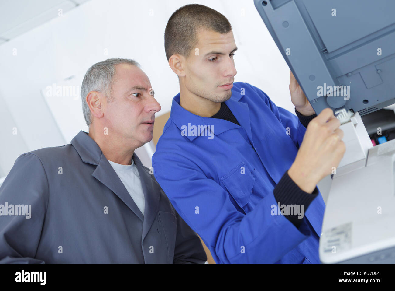 technician and apprentice stand in industry Stock Photo - Alamy