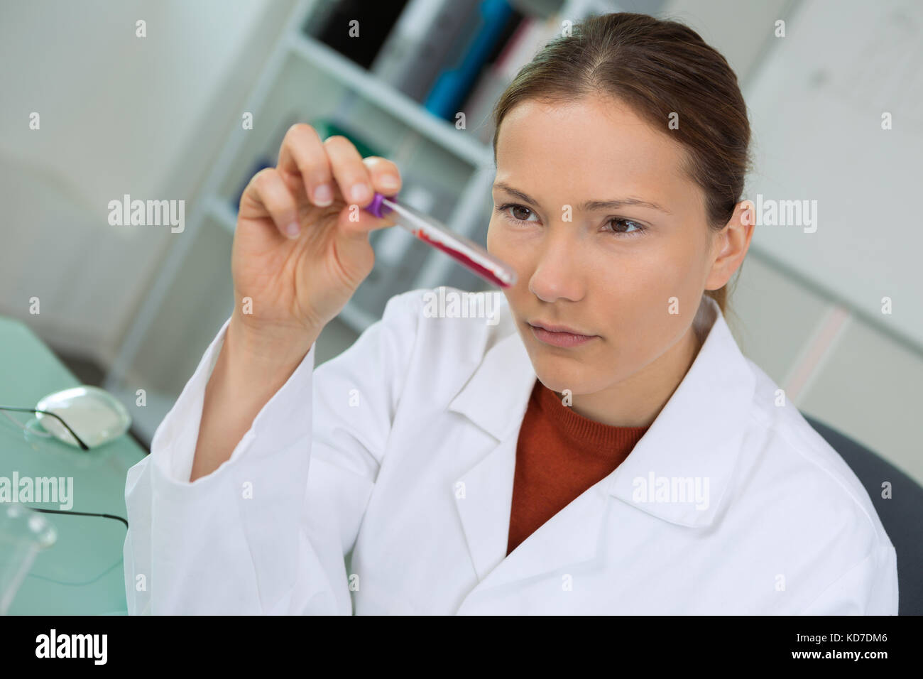 Testee Woman examining test tube Stock Photo - Alamy