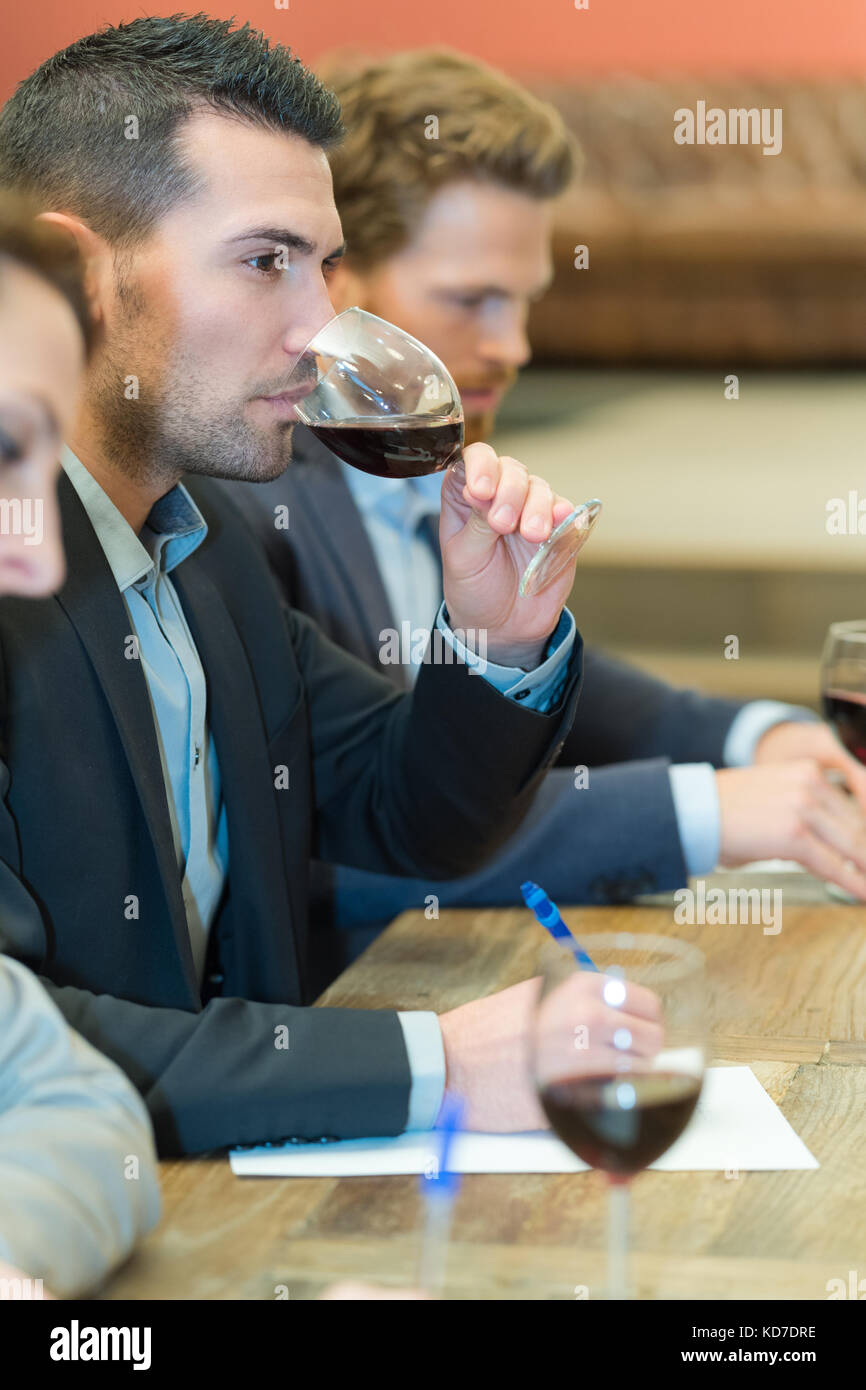 confident young man drinking wine in restaurant Stock Photo - Alamy