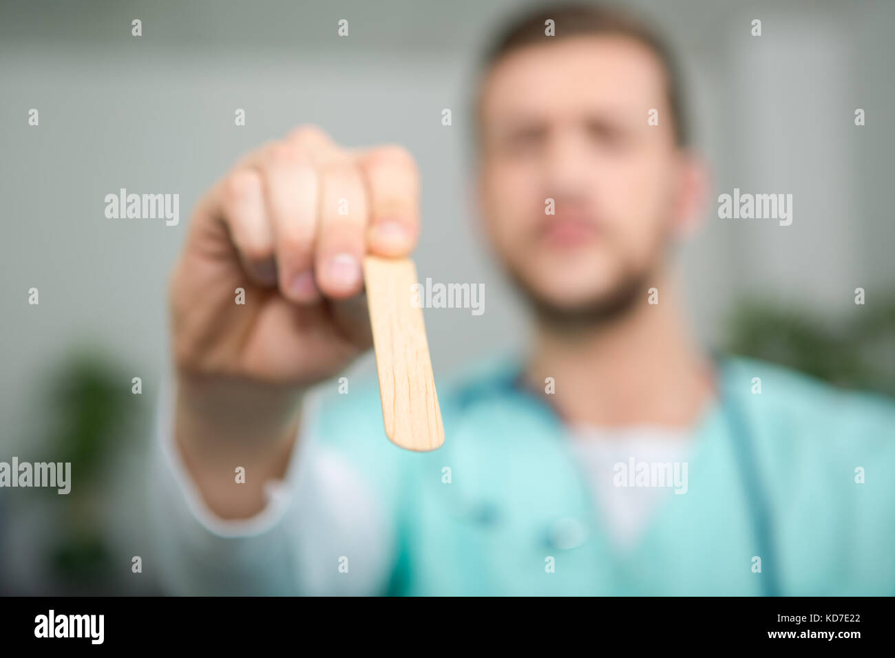 male doctor showing wooden stick used to auscult patients Stock Photo