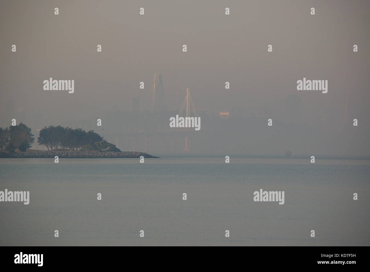 San Francisco, California, USA. 10th Oct, 2017. Sunrise on the San Francisco and Bay Bridge Covered In Smoke From The Napa and Sonoma Fires in California Credit: Peter Graham/Alamy Live News Stock Photo