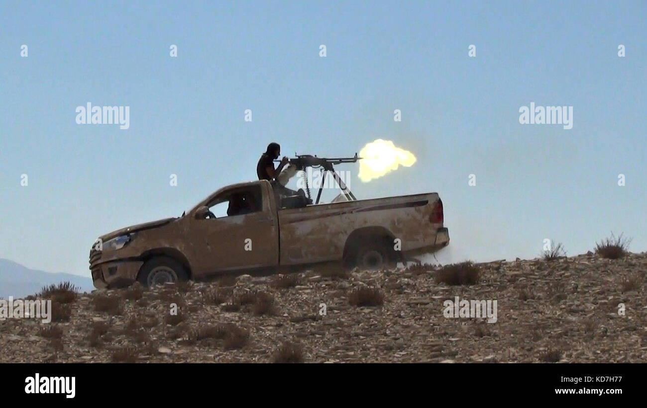 Al Qaryatayn, Syria. 10th Oct, 2017. Still image taken from an ISIS propaganda video released October 10, 2017 showing the Islamic State militants firing a heavy machine gun from the back of a pickup truck during battles in Qaryatain, Syria. After losing territory the Islamic State staged a week-long counterattack seizing the central Syrian town near Palmyra. Credit: Planetpix/Alamy Live News Stock Photo