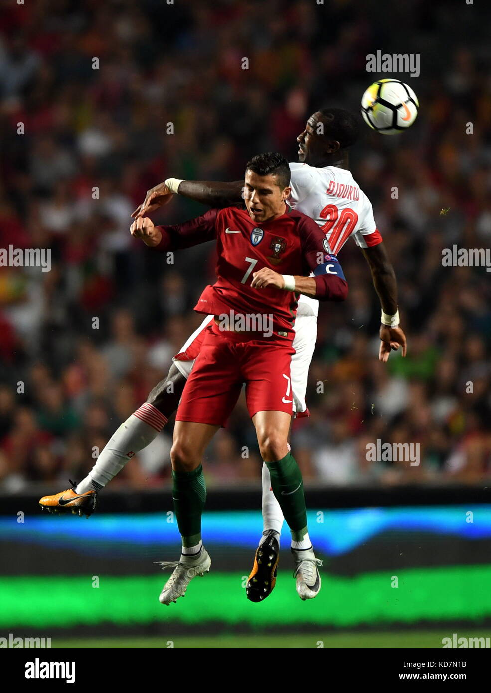 Lisbon, Portugal. 10th Oct, 2017. Cristiano Ronaldo (L) of Portugal vies with Johan Djourou of Switzerland during the FIFA World Cup 2018 Qualifiers Group B match between Portugal and Switzerland at the Luz stadium in Lisbon, Portugal, on Oct. 10, 2017. Portugal won 2-0. Credit: Zhang Liyun/Xinhua/Alamy Live News Stock Photo