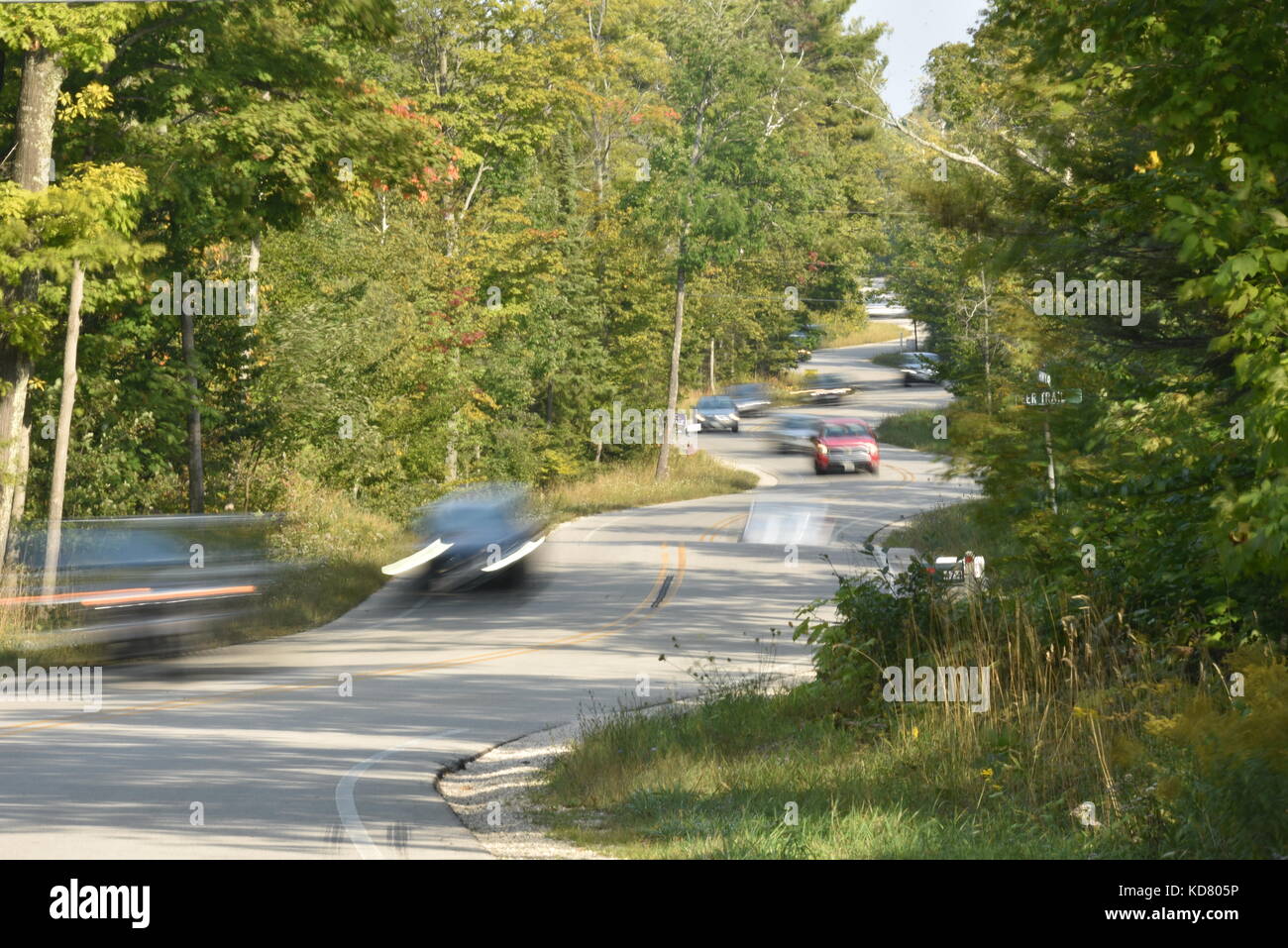 Winding, curvy road in Door County, Highway 42, near Death's Door and ferry departure point for Washington Island. Traffic coming from ferry. Stock Photo