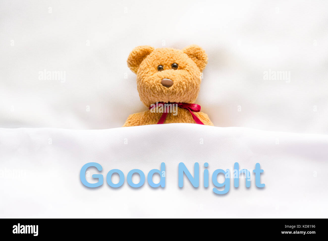 Teddy Bear lying in the white bed with message 