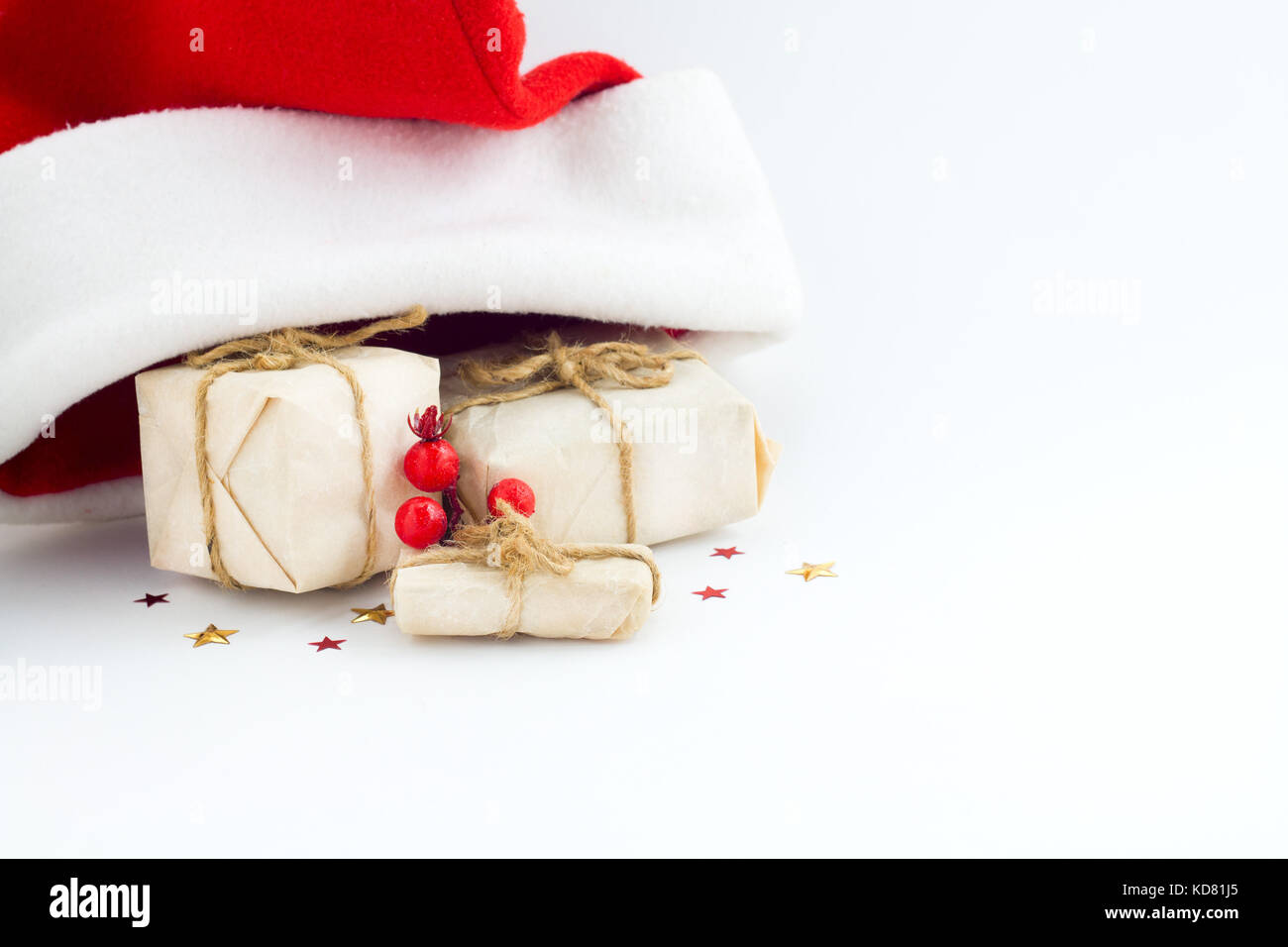 Christmas background with decorations and gift boxes and santa hat on white background Stock Photo