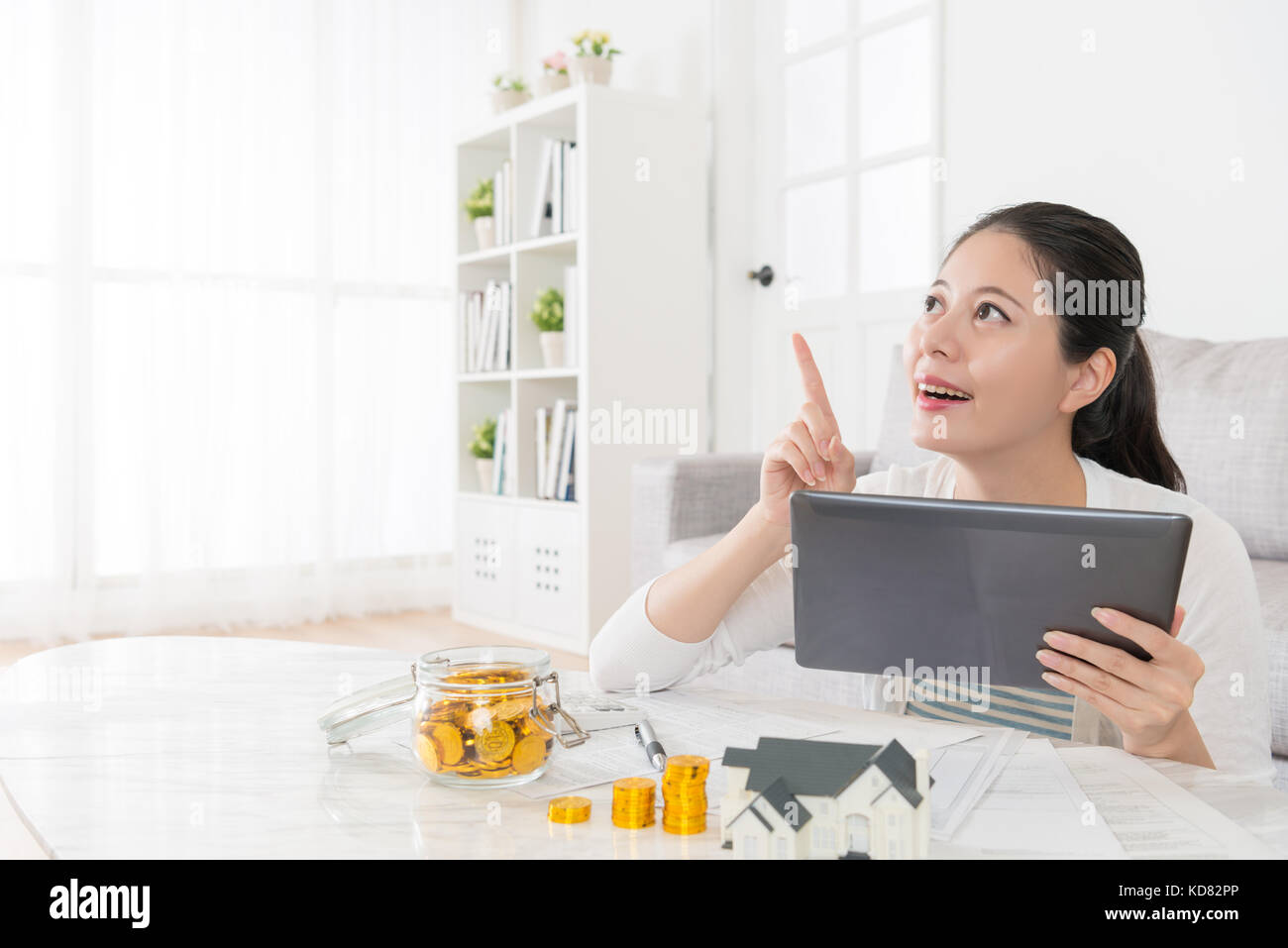 happy beautiful housewife using mobile pad computer daydreaming and ...