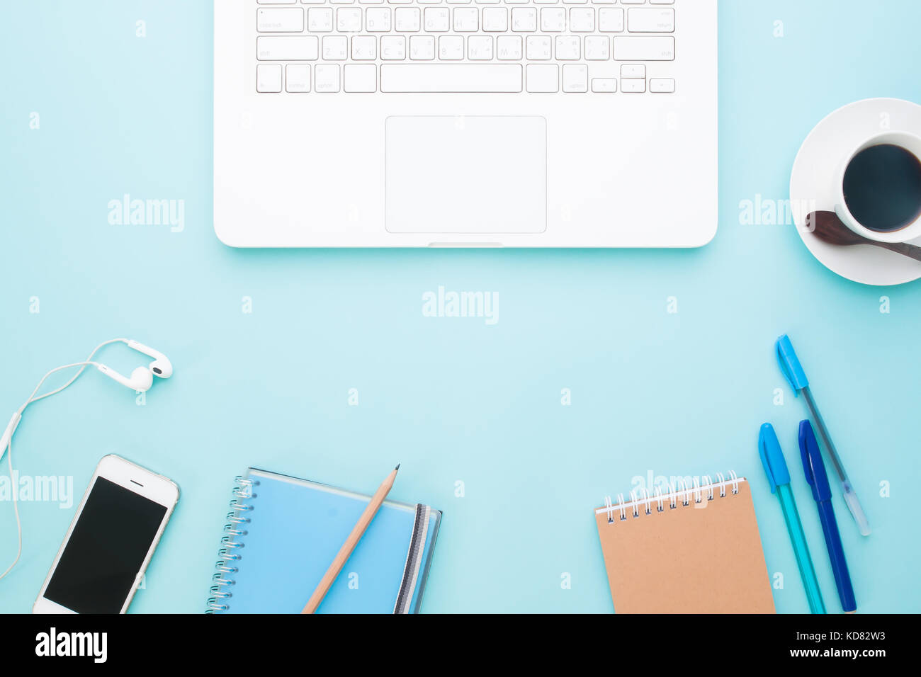 Flat lay of workspace with white laptop computer, smartphone, coffee ...