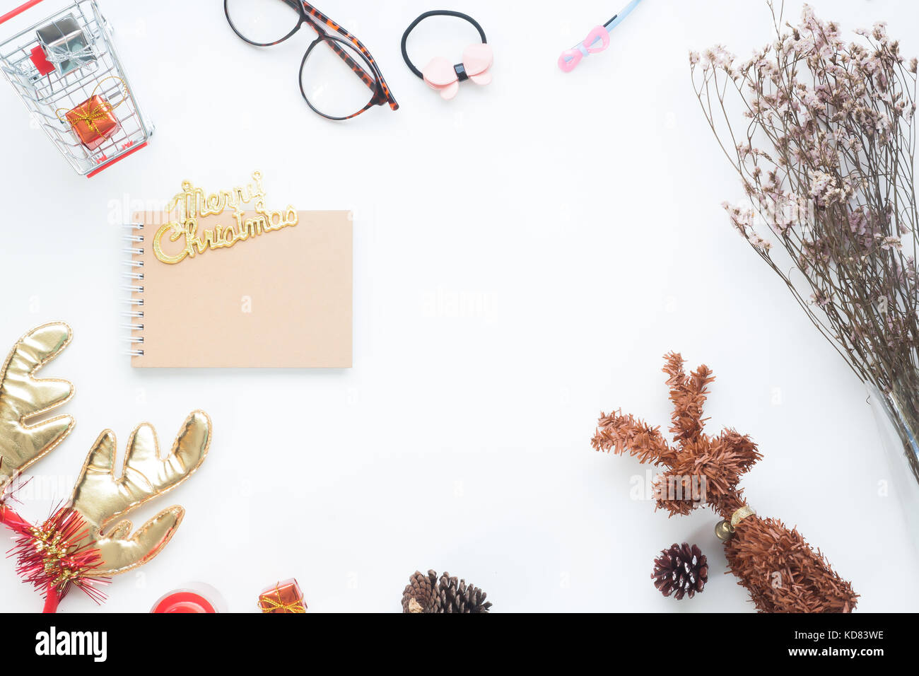 Creative flat lay of Christmas decorations and notebook on white background with copy space Stock Photo