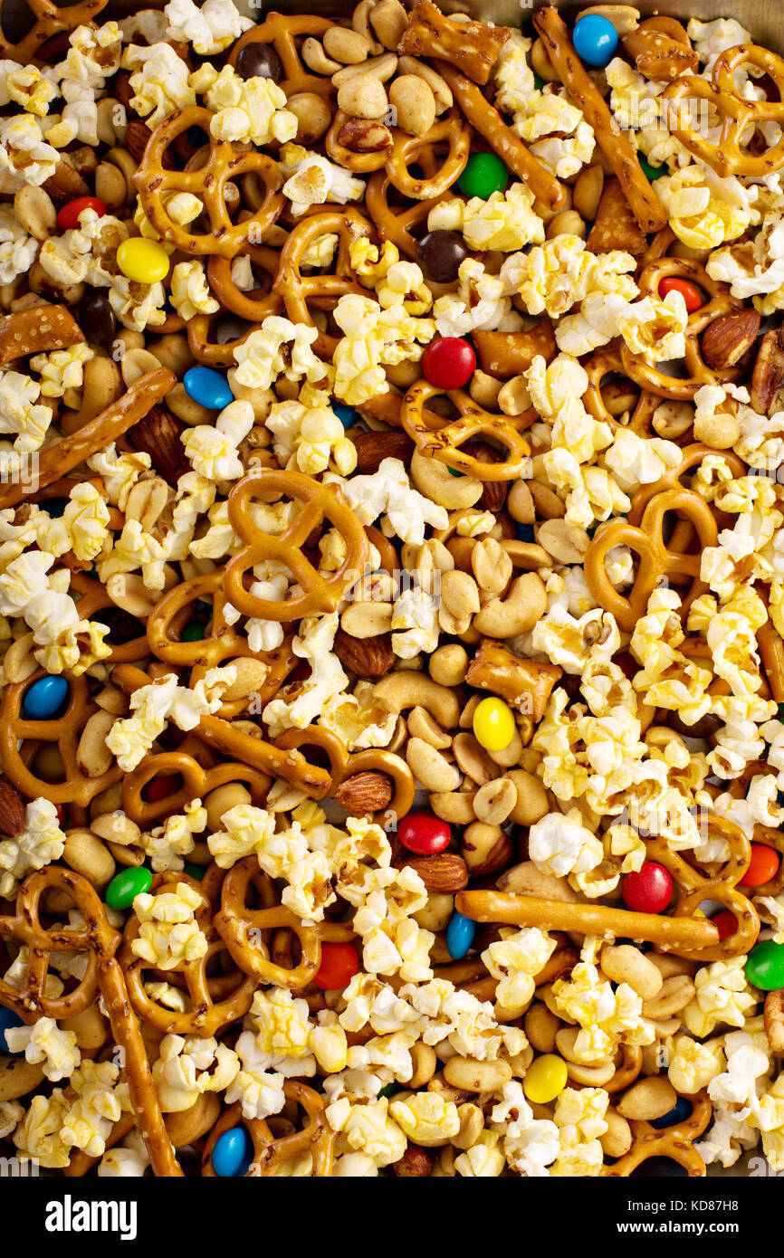 Homemade trail mix with chocolate candy, popcorn, pretzels and nuts
