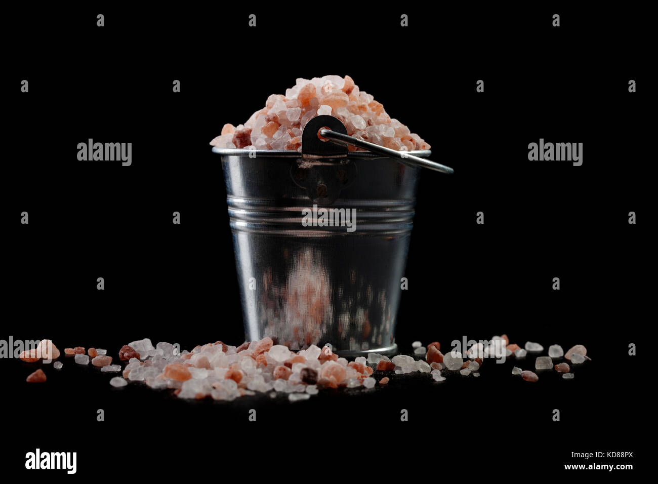 Silver Metal Bucket With Himalayan Salt on Black Background Stock Photo