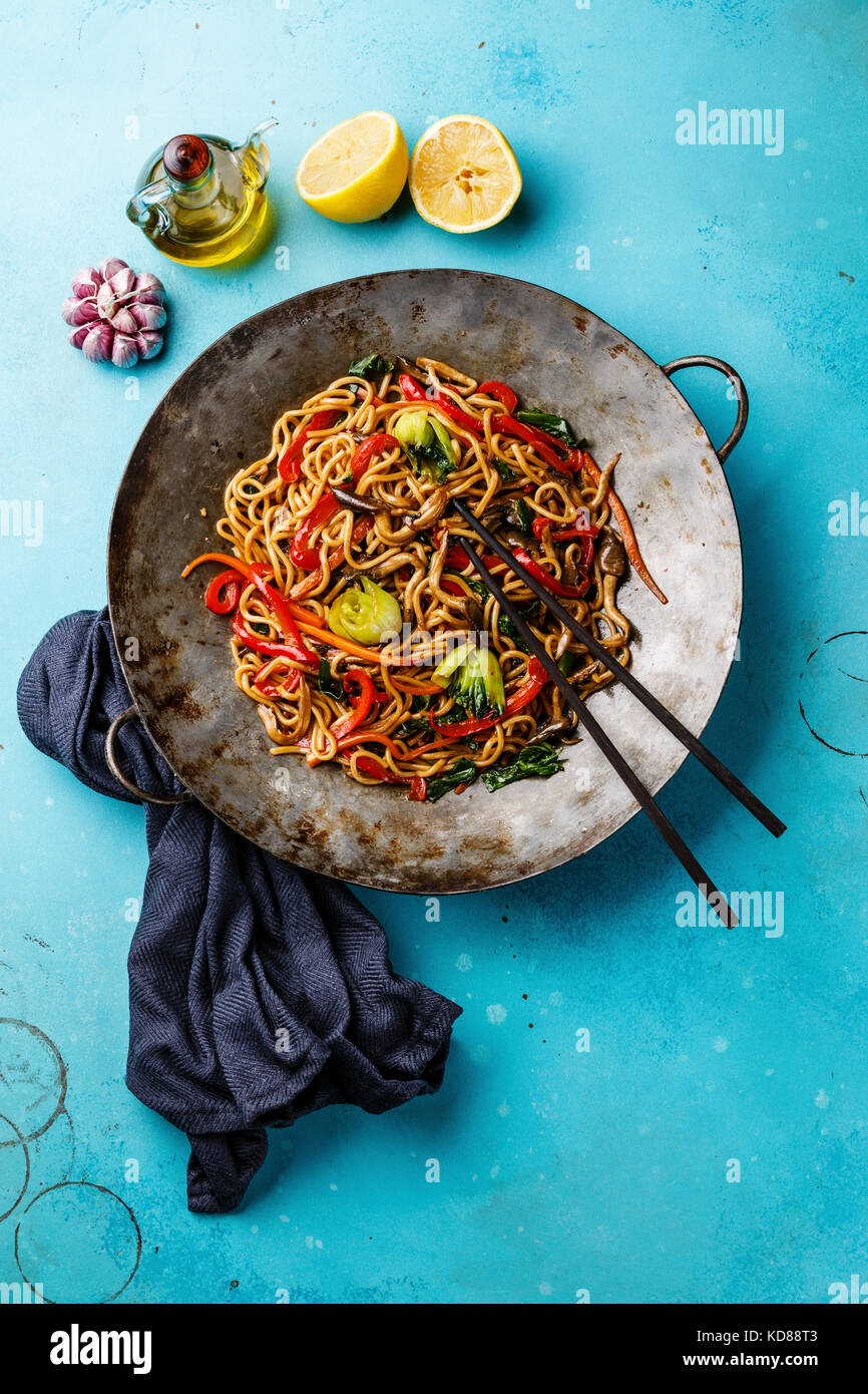 Udon stir fry noodles with oyster mushrooms and vegetables in wok pan