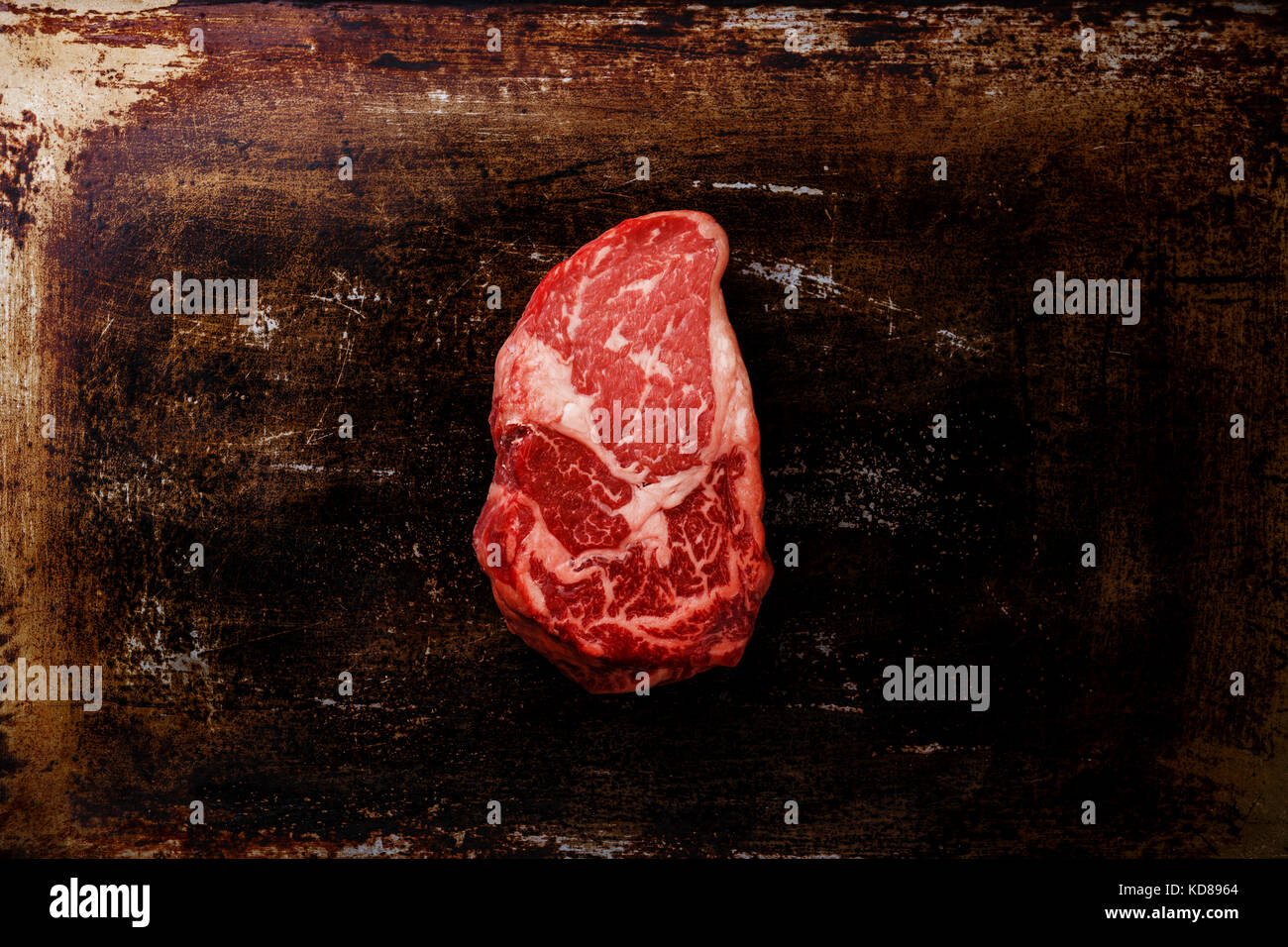 Raw fresh marbled meat Steak Rib eye Black Angus on dark metal background Stock Photo