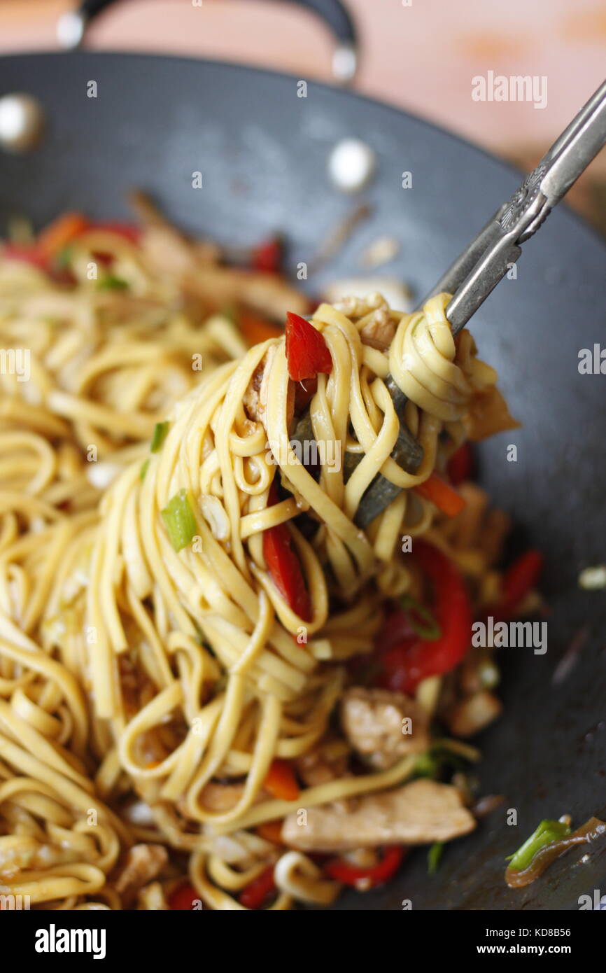 Vegetable noodle dish in wok ready to serve, with noodle rolled around