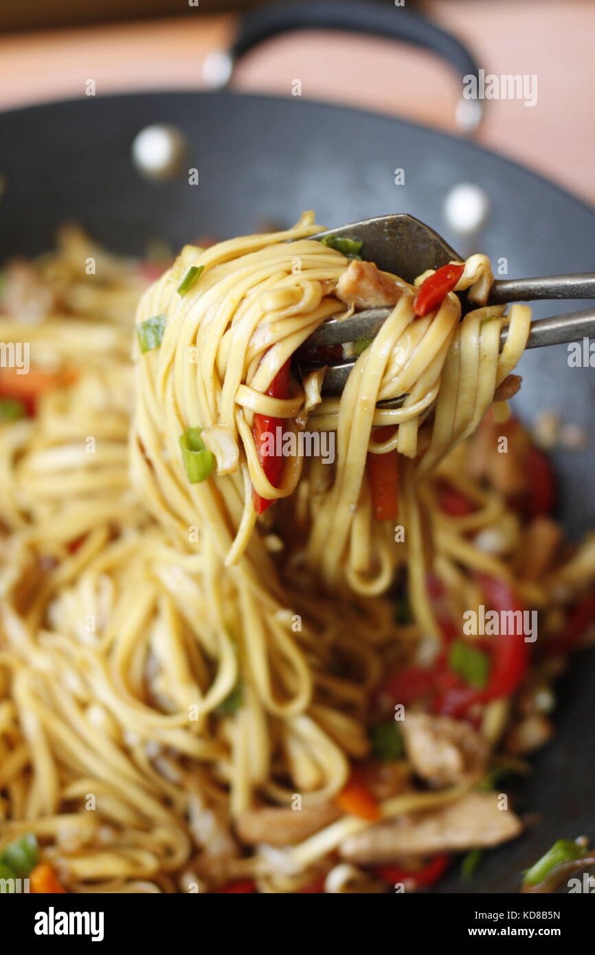 Vegetable noodle dish in wok ready to serve, with noodle rolled around pasta  picker Stock Photo - Alamy