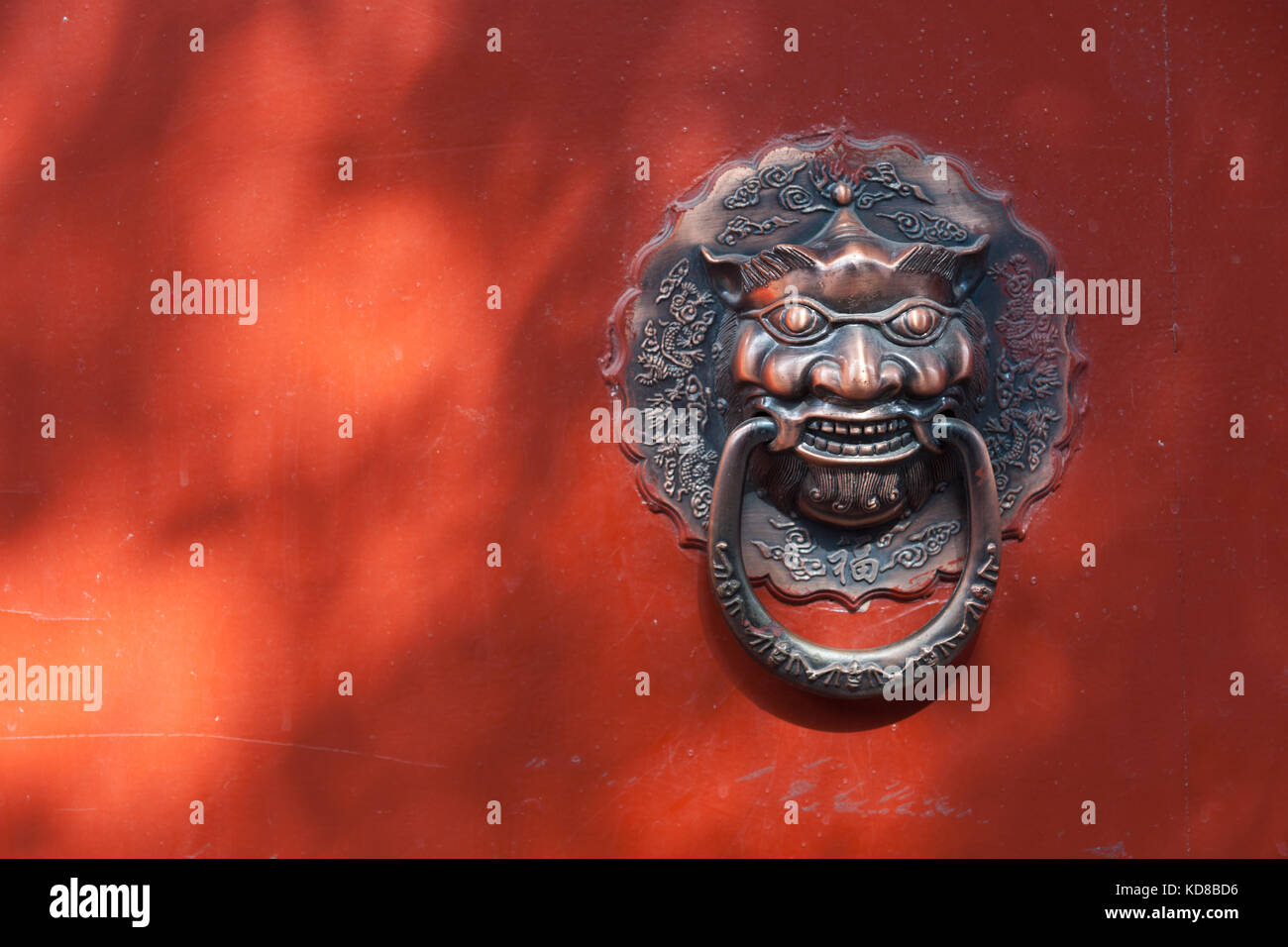 Classic Chinese bronze lion head door knocker at Hutong alley in Beijing, China Stock Photo